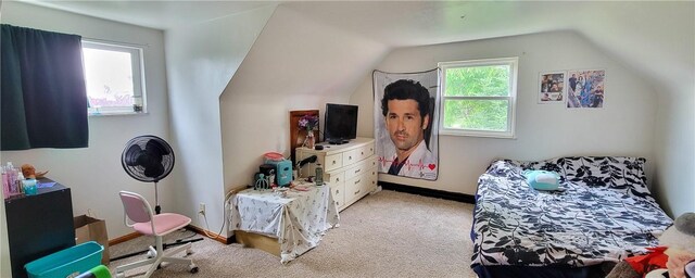 carpeted bedroom with lofted ceiling