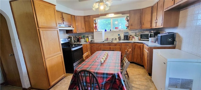 kitchen featuring ceiling fan, appliances with stainless steel finishes, sink, and backsplash