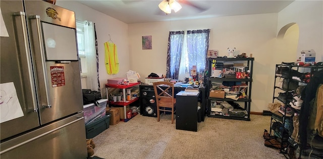 home office with light carpet and ceiling fan