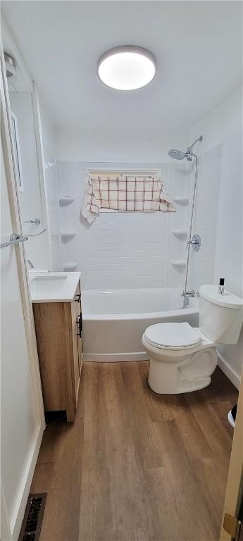 full bathroom featuring vanity, shower / bathing tub combination, wood-type flooring, and toilet