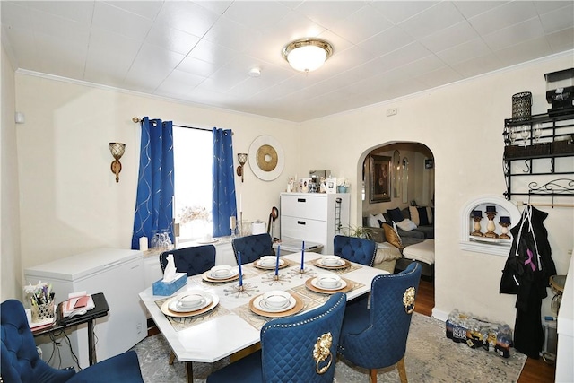 dining area featuring hardwood / wood-style flooring and ornamental molding