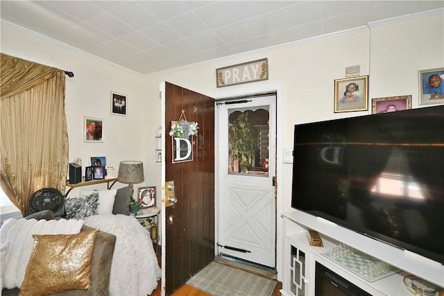 interior space featuring crown molding and wood-type flooring