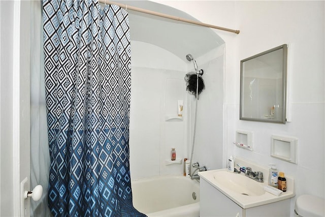 full bathroom featuring vanity, shower / bath combo with shower curtain, and toilet