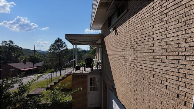 view of side of home featuring a balcony