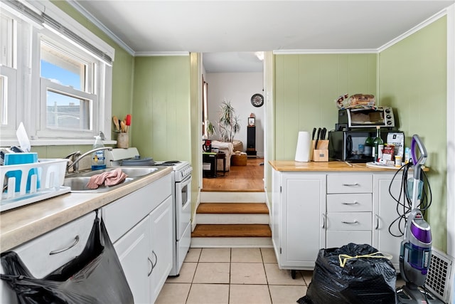 kitchen featuring range, white cabinetry, and crown molding