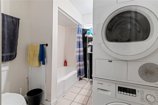 interior space with stacked washer and dryer, tile patterned flooring, toilet, and shower / tub combo