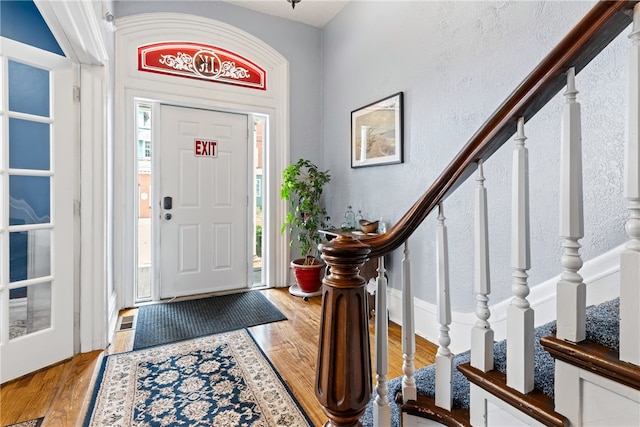 entryway with hardwood / wood-style floors