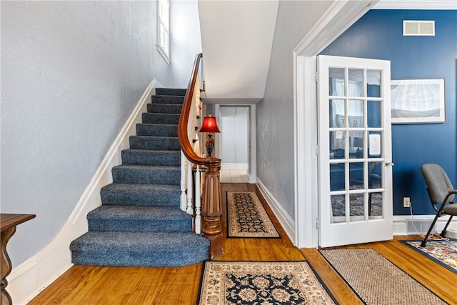 stairway featuring hardwood / wood-style flooring