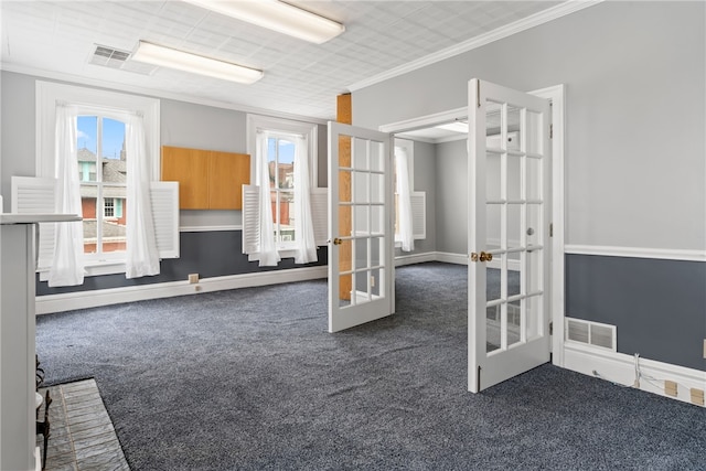 interior space featuring crown molding, dark colored carpet, and plenty of natural light