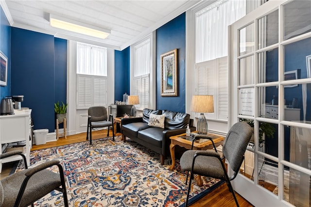 sitting room featuring crown molding and hardwood / wood-style floors