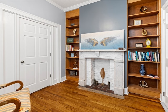 living room with ornamental molding, built in features, and dark wood-type flooring