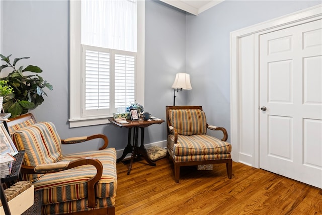 sitting room featuring crown molding and hardwood / wood-style floors