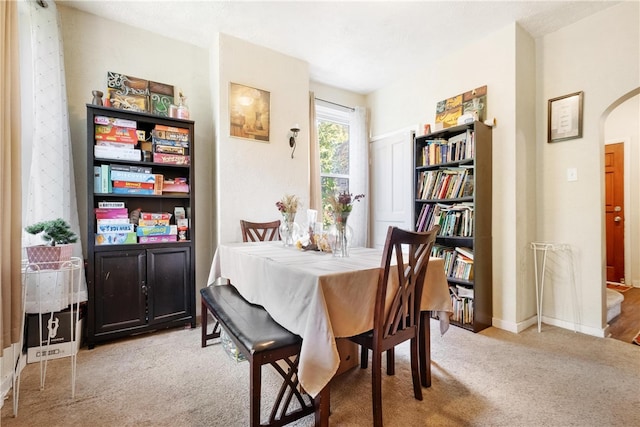 dining room featuring light carpet