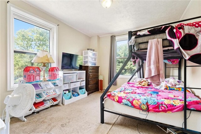 bedroom featuring carpet floors, a textured ceiling, and ornamental molding