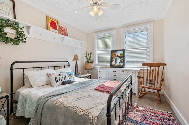 carpeted bedroom featuring a textured ceiling and ceiling fan