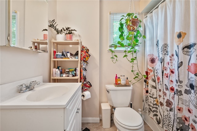 bathroom with vanity, curtained shower, tile patterned floors, and toilet