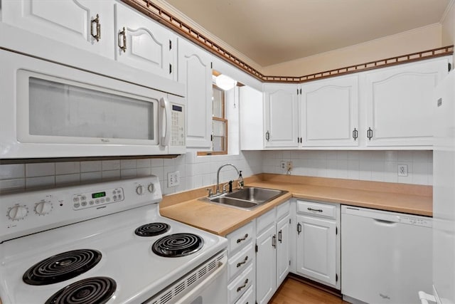 kitchen featuring sink, white cabinets, decorative backsplash, light hardwood / wood-style floors, and white appliances