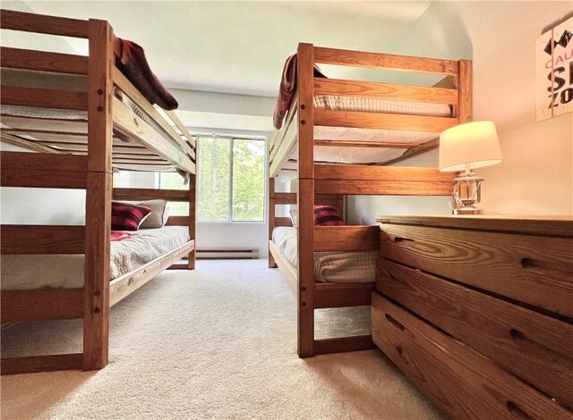 bedroom with a baseboard radiator and light colored carpet