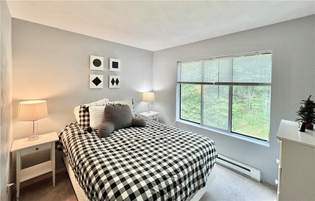 carpeted bedroom with a baseboard radiator