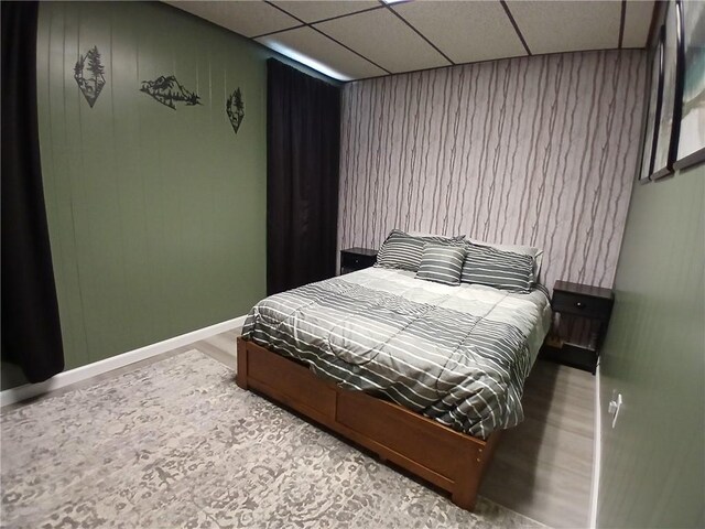 540 Market St, Fairfield Twp, PA 15923 - bedroom featuring wooden walls, a drop ceiling, and baseboards