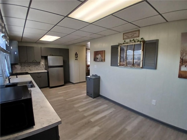 540 Market St, Fairfield Twp, PA 15923 - kitchen with a paneled ceiling, light wood-style flooring, light countertops, and freestanding refrigerator