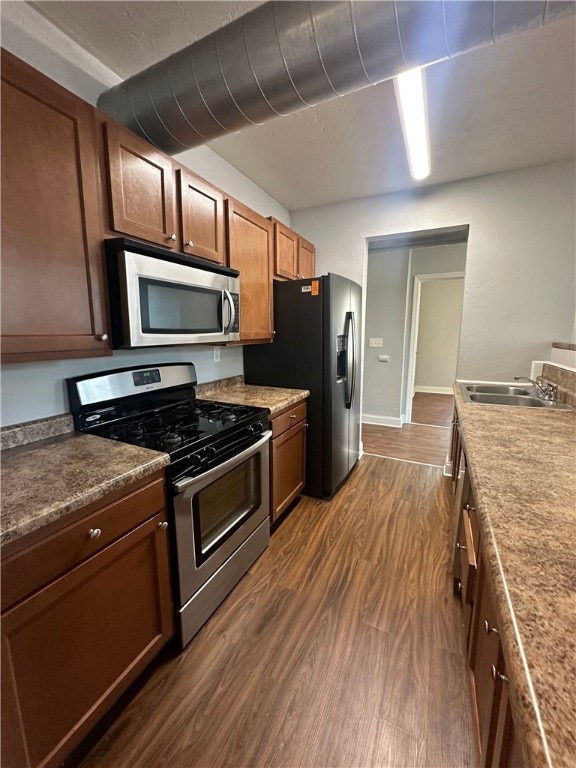 kitchen featuring sink, dark hardwood / wood-style flooring, and stainless steel appliances