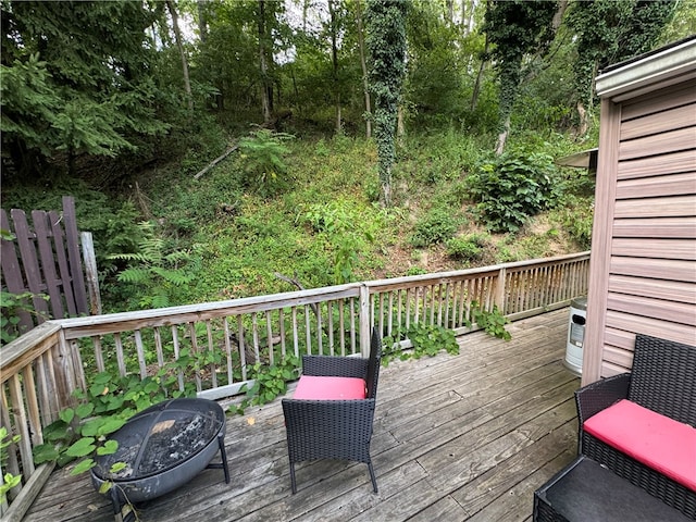 wooden terrace featuring a fire pit