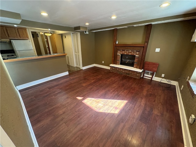 unfurnished living room with a fireplace and dark hardwood / wood-style floors