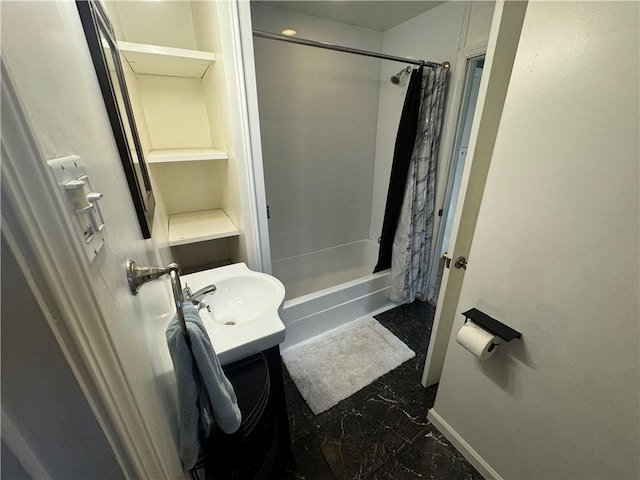 bathroom featuring vanity and shower / bathtub combination with curtain