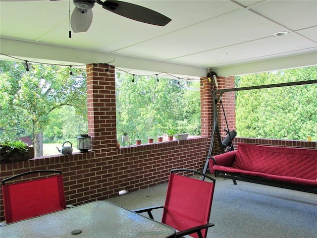 sunroom / solarium with plenty of natural light and ceiling fan