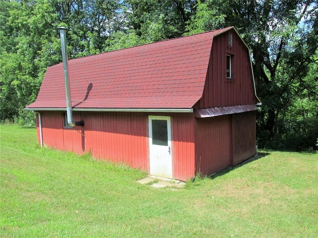 view of outdoor structure featuring a lawn