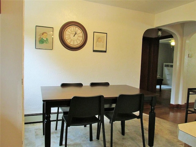 dining area featuring a baseboard heating unit