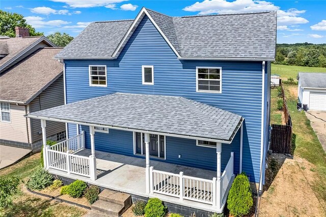 rear view of property with a porch