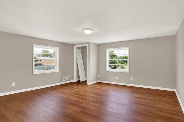 unfurnished room featuring dark wood-type flooring