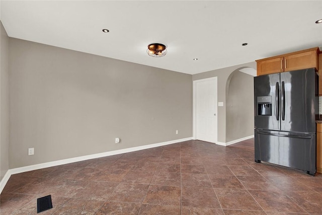 kitchen featuring stainless steel fridge with ice dispenser