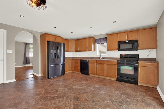 kitchen with a healthy amount of sunlight, sink, and black appliances