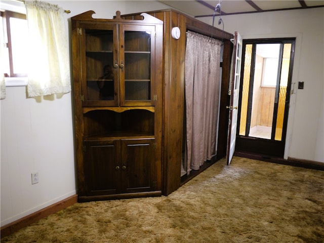 corridor with dark colored carpet