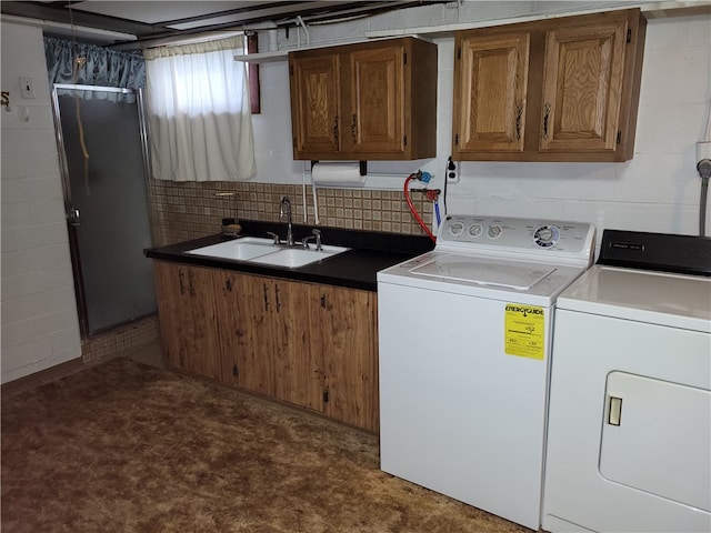 laundry room featuring washer and dryer, cabinets, and sink