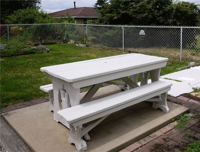 view of storm shelter with a lawn and a patio area