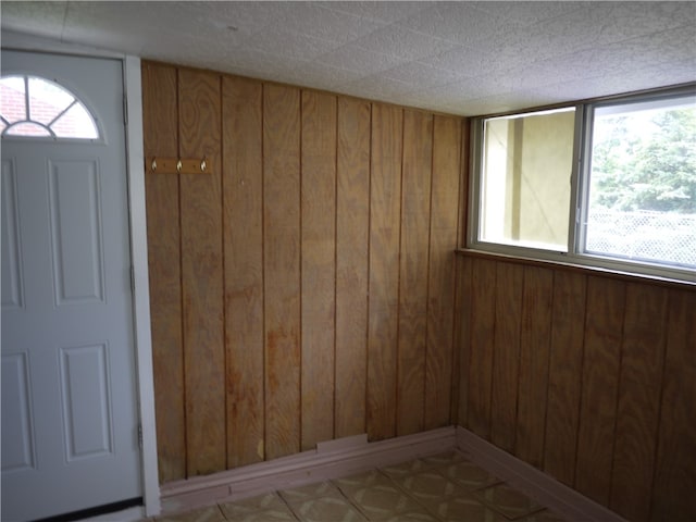 spare room with wood walls