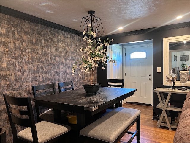 dining room with a textured ceiling and hardwood / wood-style flooring