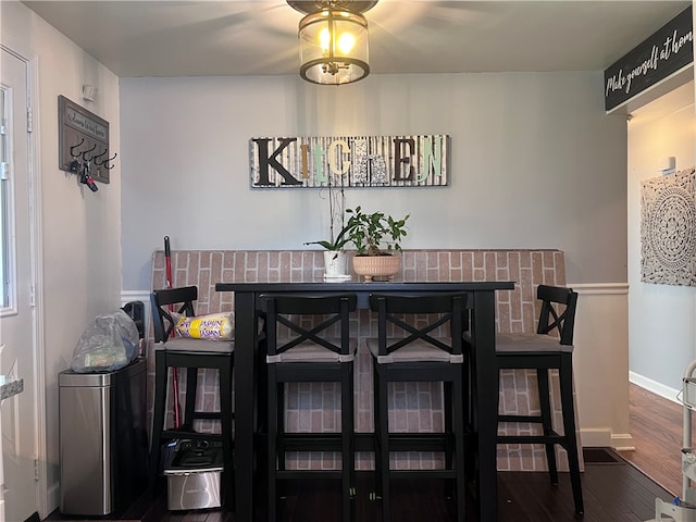 dining room with dark hardwood / wood-style flooring