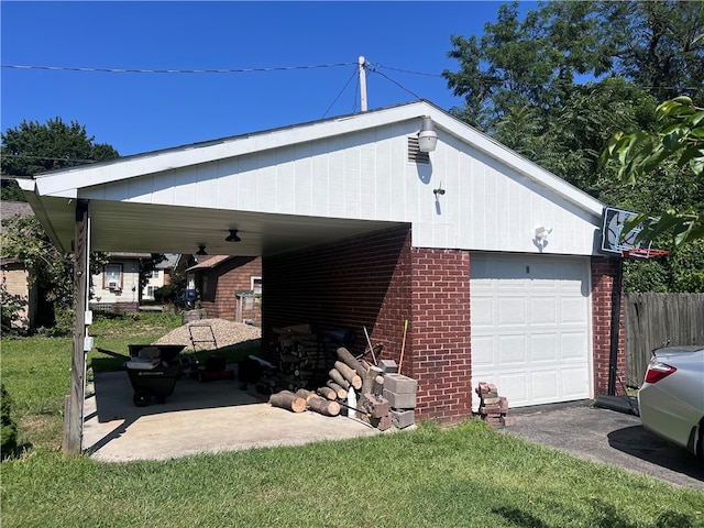 view of side of home featuring a garage, a yard, and a carport