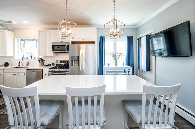 kitchen featuring plenty of natural light, appliances with stainless steel finishes, dark hardwood / wood-style floors, and white cabinetry