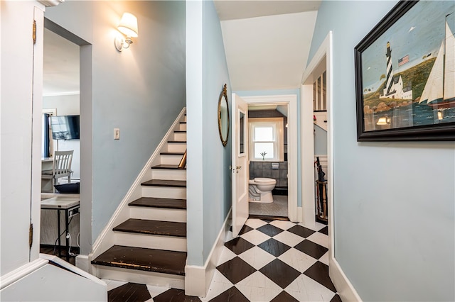 staircase featuring light tile patterned floors