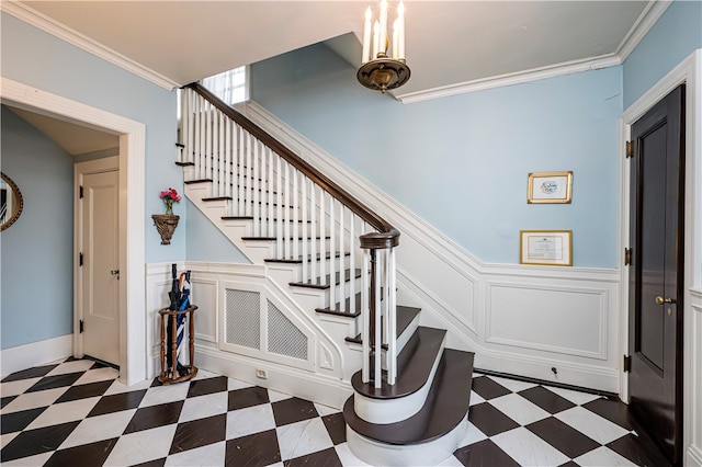 staircase with tile patterned flooring and crown molding