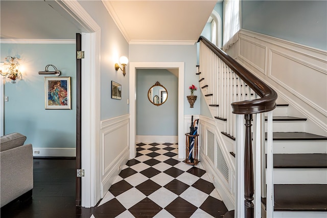 staircase with ornamental molding and dark tile patterned flooring