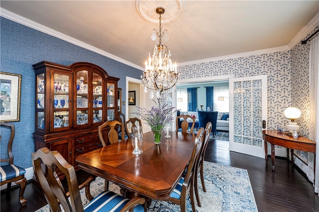 dining room featuring a notable chandelier, crown molding, and dark wood-type flooring