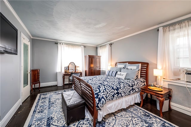 bedroom with dark hardwood / wood-style floors and ornamental molding