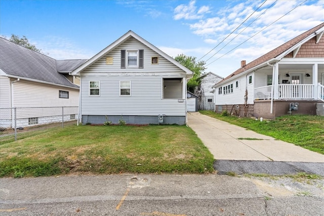 view of front of house with covered porch and a front yard